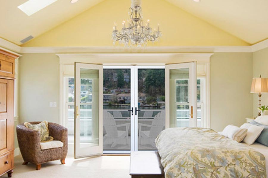 French doors with large glass panels and glass block windows on either side bringing natural light into living room