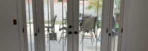 Modern french doors to porch with large, clear windows and clear sidelights providing tons of natural light