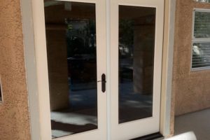 French doors installed in home under construction with double pane window