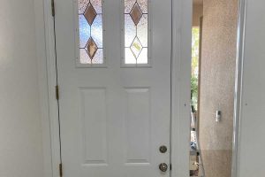 front door with two patterned glass panels at home entryway